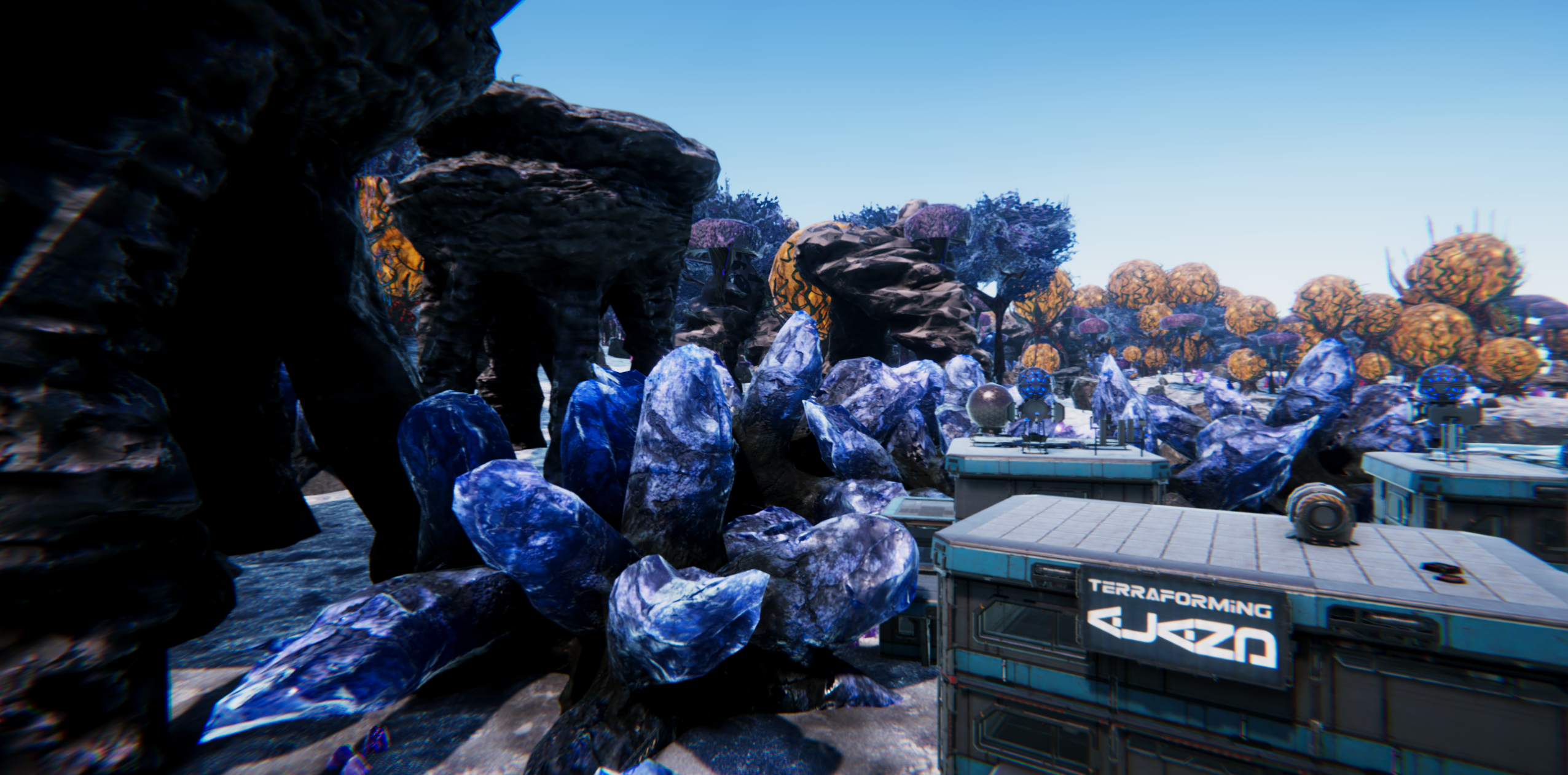 An armored explorer overlooks a vast and unfamiliar alien landscape.